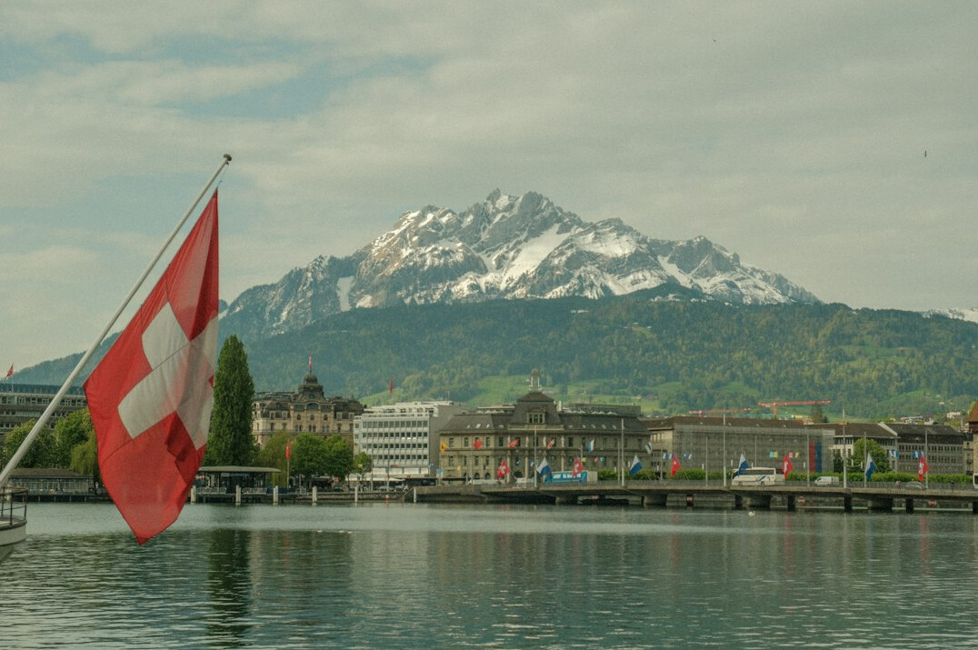 swiss flag on mountain