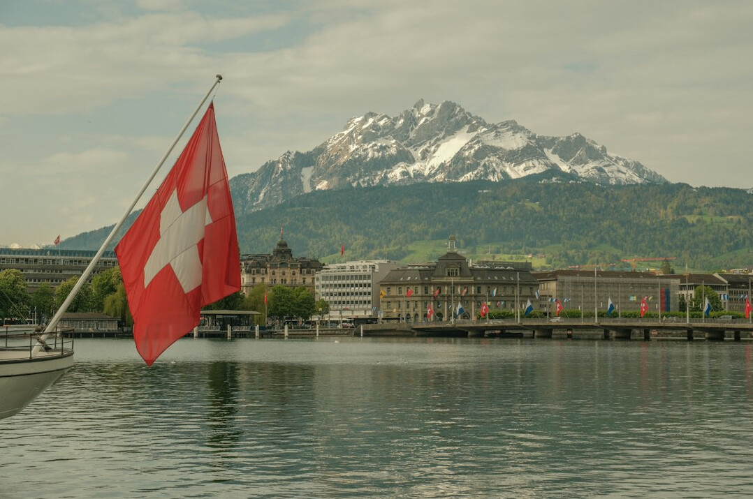 swiss flag and mountains